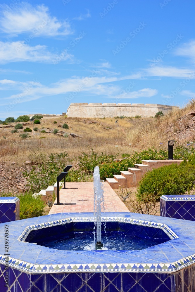 Modern blue tiled fountain at the top of the hill with the fort to the rear, Castro Marim, Algarve, Portugal.