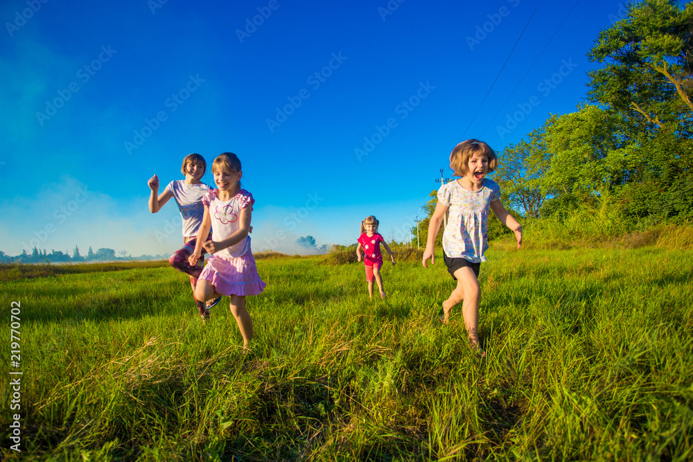 Group of happy kids running in green summer field Group of happy kids running in green summer field