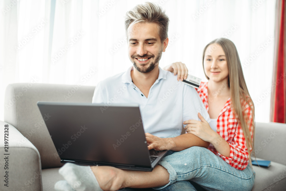 Couple looks on laptop screen, fees on vacation Couple looks on laptop screen, fees on vacation