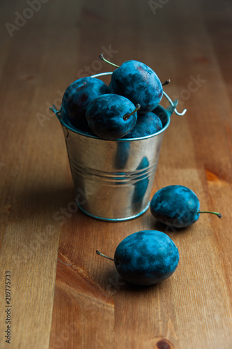 Fresh Plums on a wooden table. Useful, tasty food. Vertical photo.