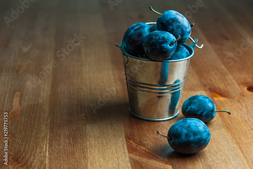 Fresh Plums on a wooden table. Useful, tasty food. Horizontal photo. Place for text.