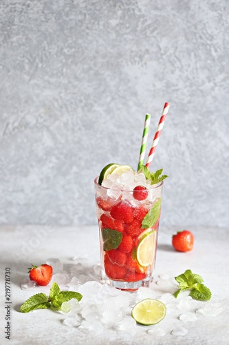 Strawberry infused water, coctail, lemonade or tea. Summer iced cold drink with strawberry, lemon and mint. Selective focus 