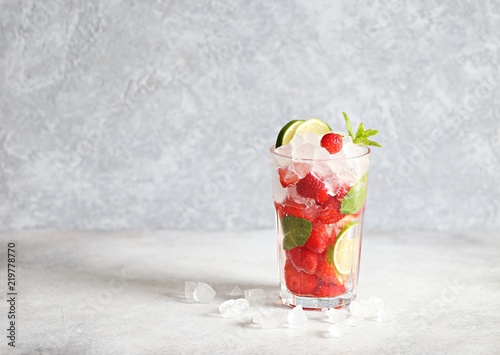 Strawberry infused water, coctail, lemonade or tea. Summer iced cold drink with strawberry, lemon and mint. Selective focus  photo