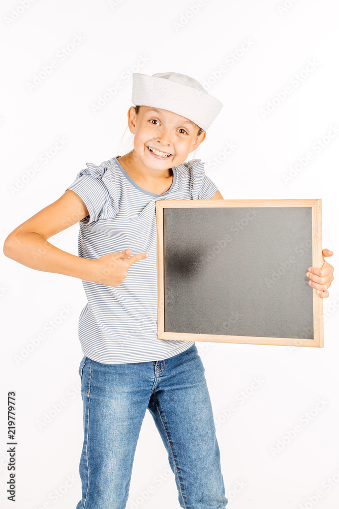 Little girl wearing a sailor costume and looking at the camera on white background. Little girl wearing a sailor costume and looking at the camera on white background.