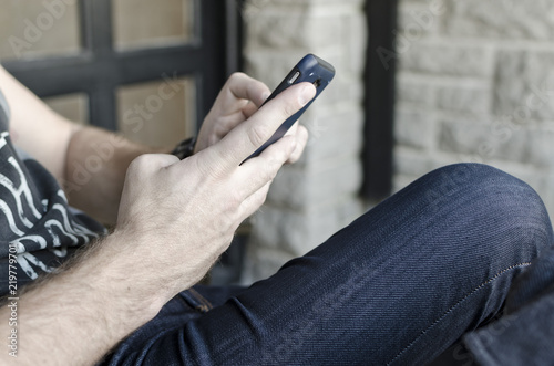 man sitting and texting © Martin