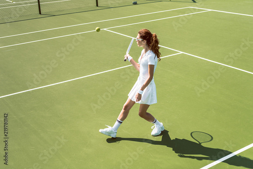 beautiful woman on white sportswear and sunglasses playing tennis on court © LIGHTFIELD STUDIOS
