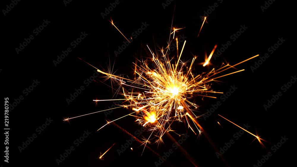 Close up several firework sparklers over black