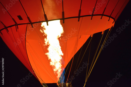 burner of a hot air balloon macro shot, hot air balloon with a yellow fire from a burner by night