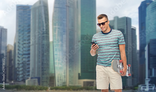 Canvas Print technology, leisure and skateboarding concept - smiling young man with skateboar