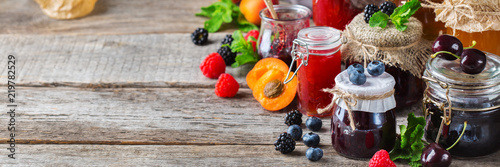 Assortment of seasonal berries and fruits jams in jars