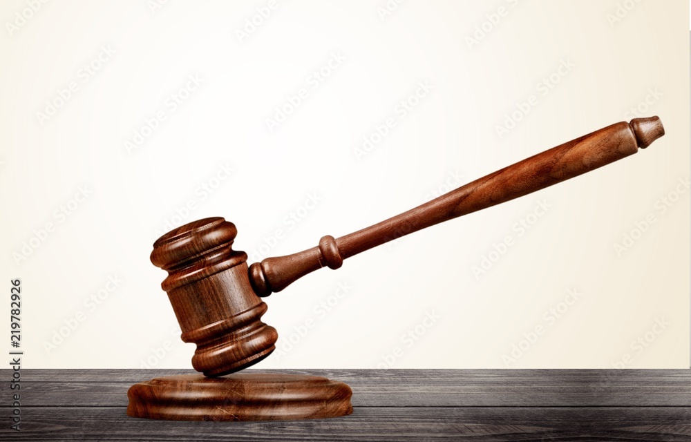 Wooden gavel on wooden table, on background Wooden gavel on wooden table, on background