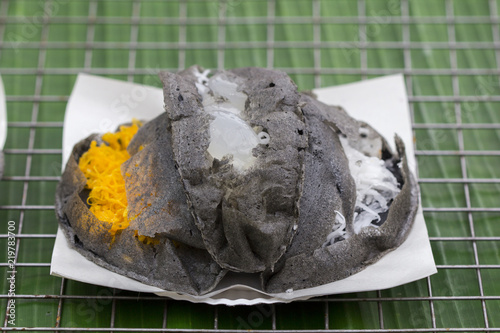 Poorman's Pancakes with coconut and sugar on tray for sale in Thailand market, Thai desserts photo