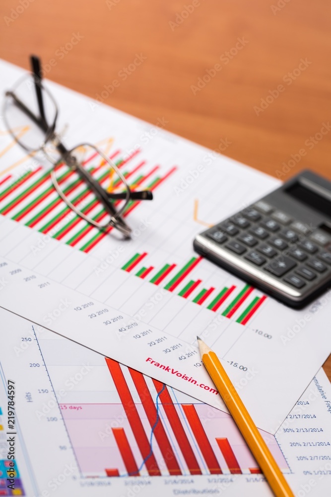 office documents with a pencil, calculator, and eye glasses office documents with a pencil, calculator, and eye glasses