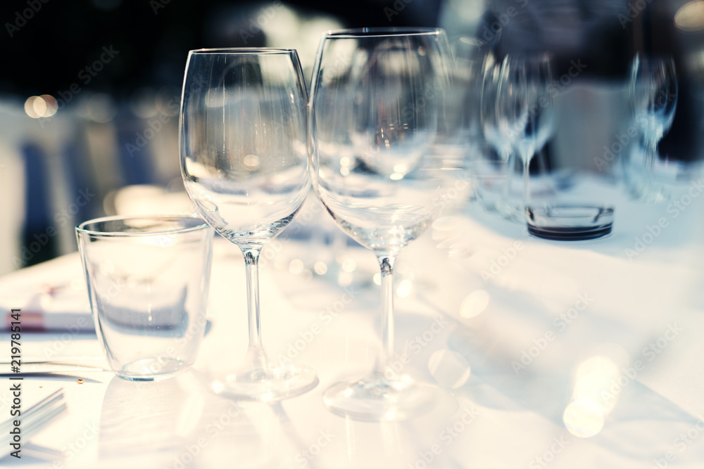 Wine glasses on dining table. Preparation for guests.