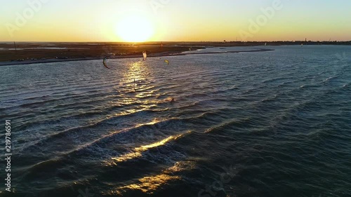 Panoramic shooting of the sea and beach, kites run by colorful kites. Slow motion photo