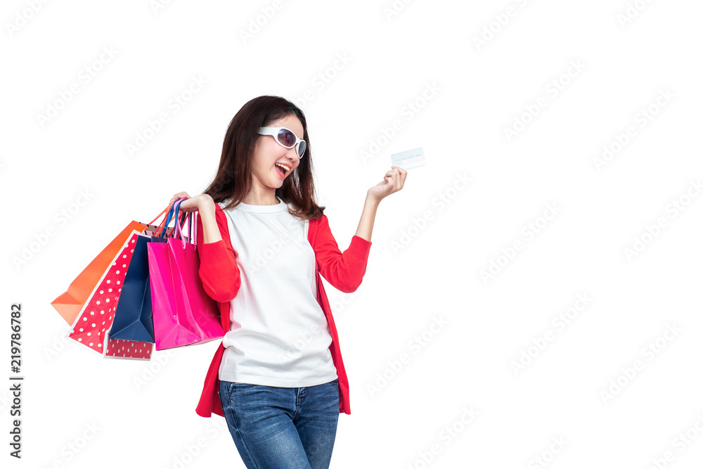 A smiling women holding shopping bag on the white background. A smiling women holding shopping bag on the white background.