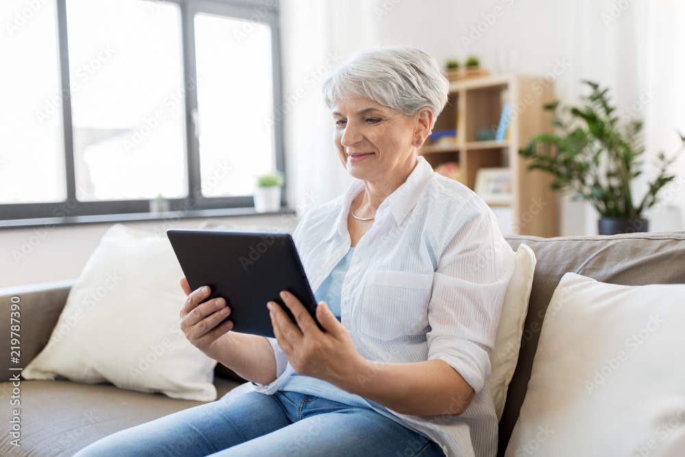 technology, age and people concept - happy senior woman with tablet pc computer at home technology, age and people concept - happy senior woman with tablet pc computer at home