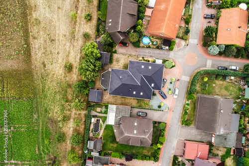 Vertical view from the air with vertical view of houses, roofs and streets of a village in northern Germany