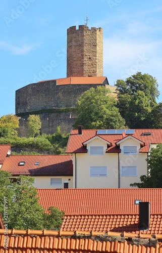 Tower of the medieval fortified castle Steinsberg (erected in the 11th century) in Sinsheim, district Weiler, and houses in the village Weiler. Baden-Wuerttemberg, Germany, Europe. photo