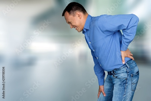 Mature man with backache isolated on white background