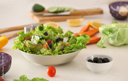 Bowl with fresh salad on table. Diet food