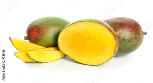 Whole and sliced mangoes on white background