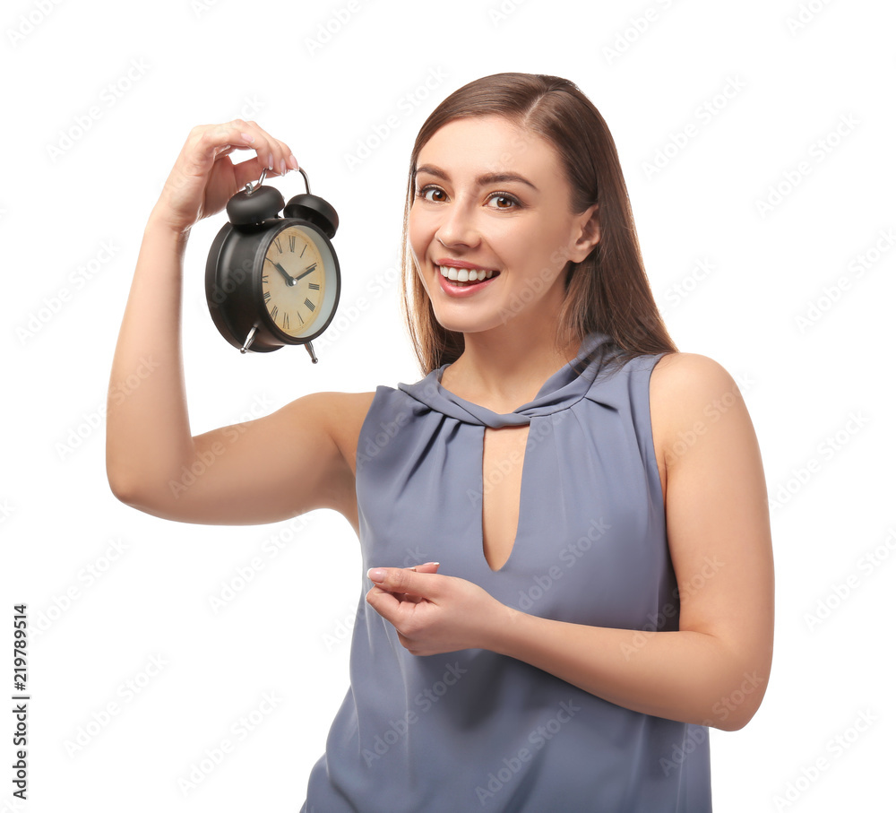 Fototapeta premium Young woman with alarm clock on white background. Time management concept