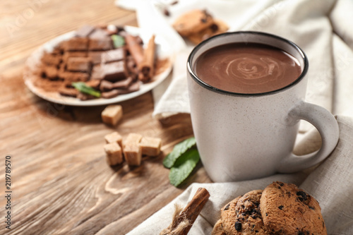 Cup of hot chocolate on wooden table photo