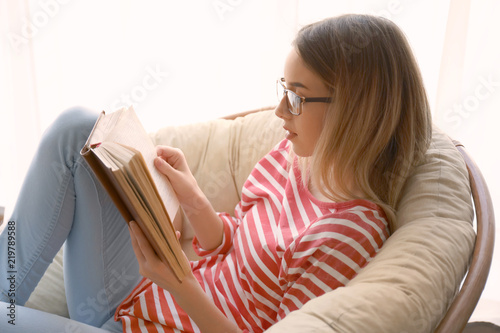 Young woman reading interes...