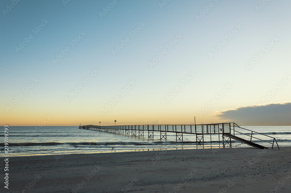 Naklejka premium Sandy beaches of Rimini shortly after dawn in winter