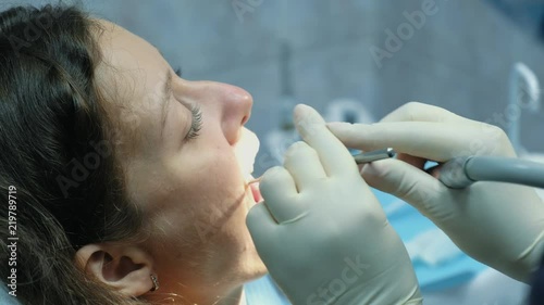 At the reception of an orthodontist. Dentist is treating the patients teeth. Visit to the stomatologist
