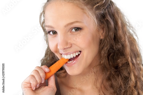 Portrait of a Young Woman Eating a Carrot