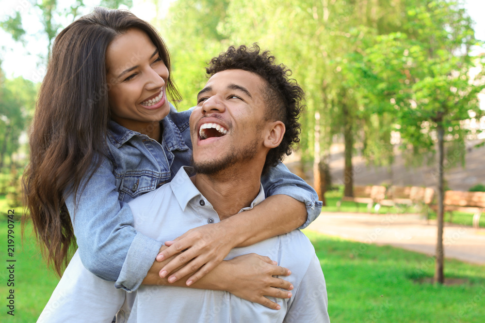 Happy African-American couple in park on spring day Happy African-American couple in park on spring day