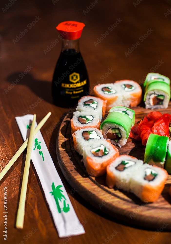 Sushi with soy sauce and sticks on a table Sushi with soy sauce and sticks on a table