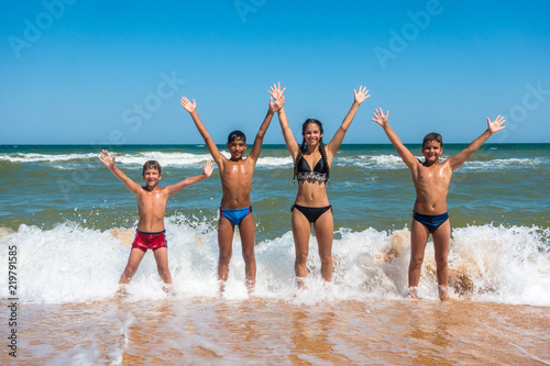 Group of four teens standing on the beach