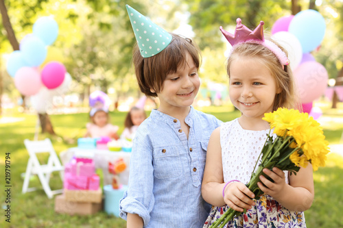 Little girl with flowers an...