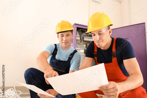 Two electricians with house...