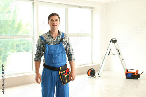 Electrician with tools in n...