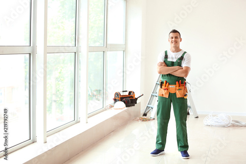 Electrician with tools in n...