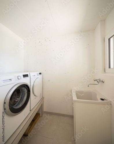 Laundry with washing machine, dryer and sink © alexandre zveiger