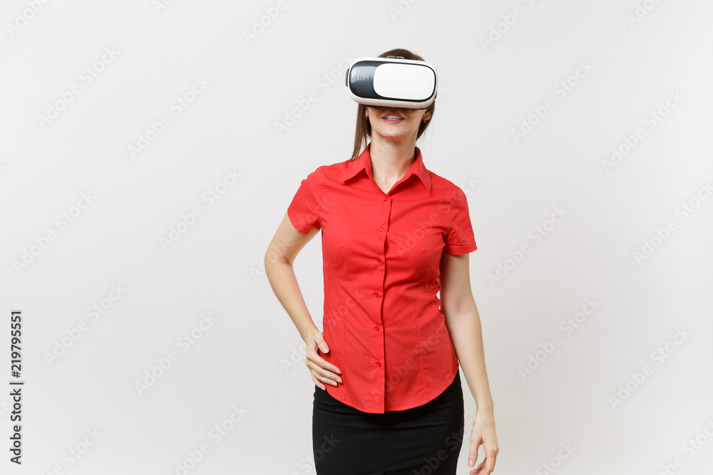 Portrait of young smart business woman in red shirt, black skirt in headset of virtual reality on head isolated on white background. Education or teaching of future in high school university concept. Portrait of young smart business woman in red shirt, black skirt in headset of virtual reality on head isolated on white background. Education or teaching of future in high school university concept.