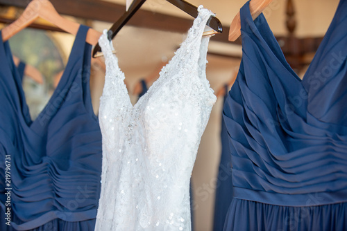 Wedding Dress and Blue bridesmaids dresses Hanging close
