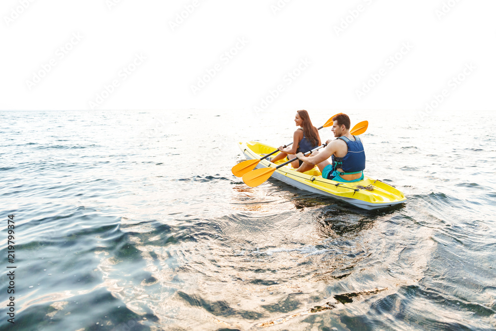 Attractive young couple kayaking on lake