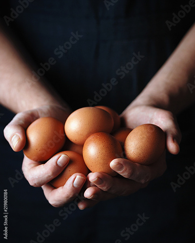 A man holds chicken fresh organic eggs. Close up. Toned picture