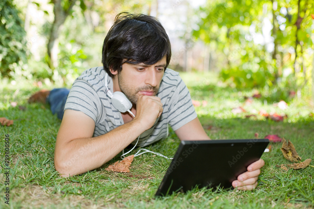 man relaxing with tablet pc man relaxing with tablet pc