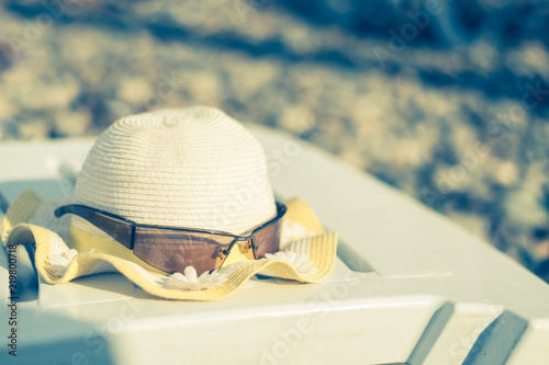 Panama and sunglasses on a sunbed on a sunny day on the beach on the Black Sea coast. Concept: beach holidays photo