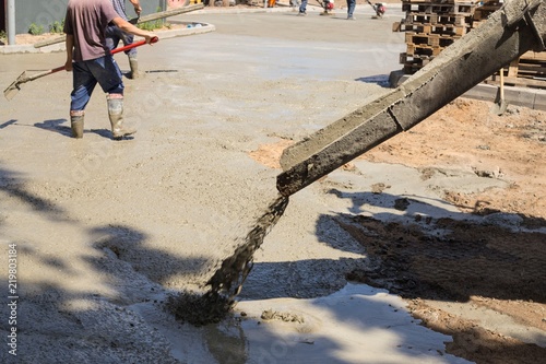 Workers, smooth concrete screed. Road-building.