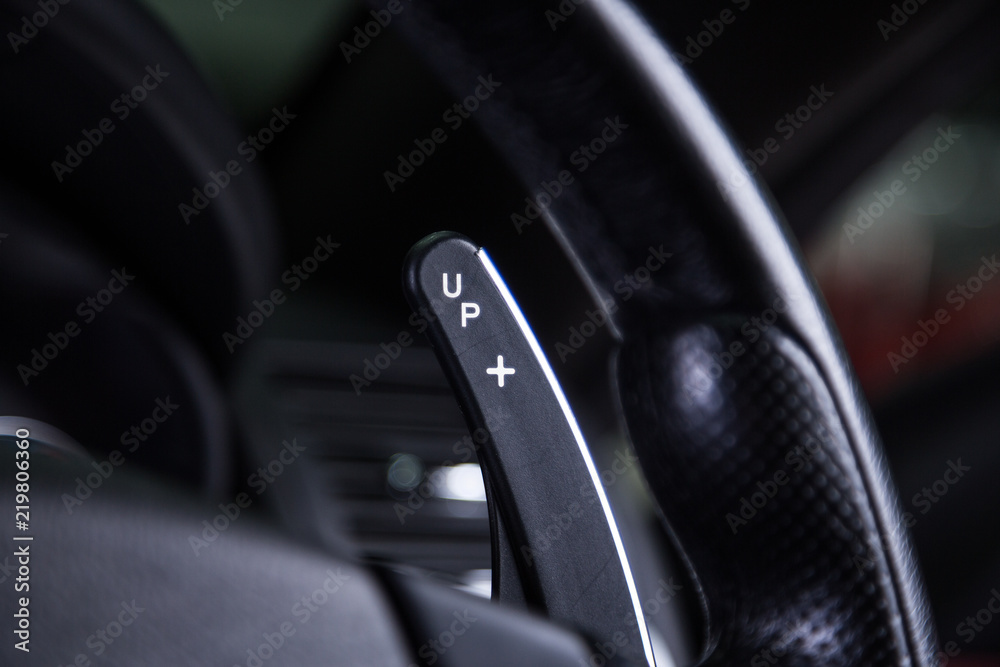 Gear paddle shift detail on black steering wheel Gear paddle shift detail on black steering wheel