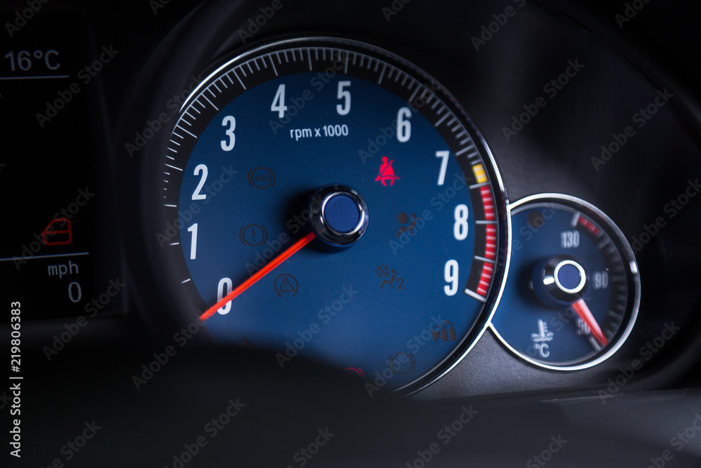 Close up of blue speedometer in sports car