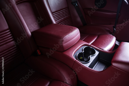 Passenger storage compartment in red leather car interior